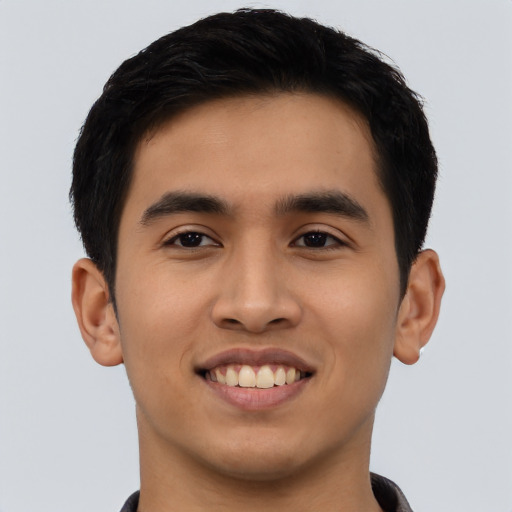 Joyful asian young-adult male with short  black hair and brown eyes