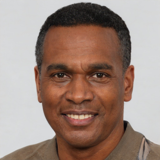 Joyful black adult male with short  black hair and brown eyes
