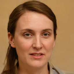 Joyful white young-adult female with medium  brown hair and blue eyes