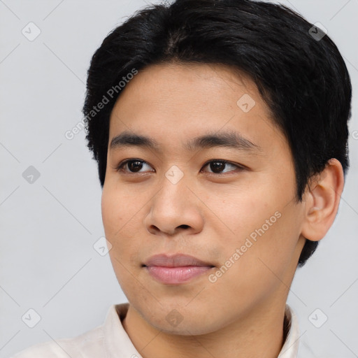 Joyful asian young-adult male with short  black hair and brown eyes