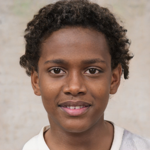Joyful black child male with short  brown hair and brown eyes