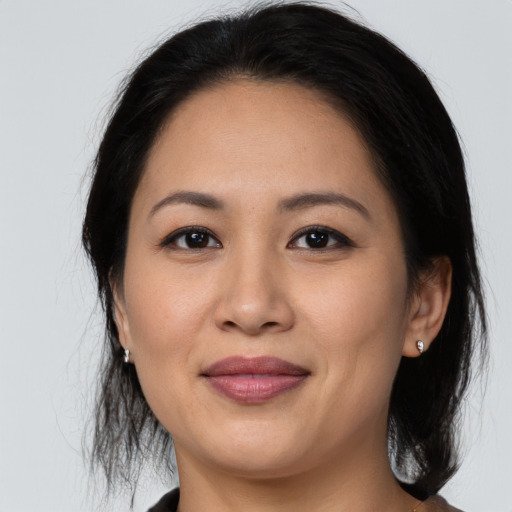 Joyful latino young-adult female with medium  black hair and brown eyes