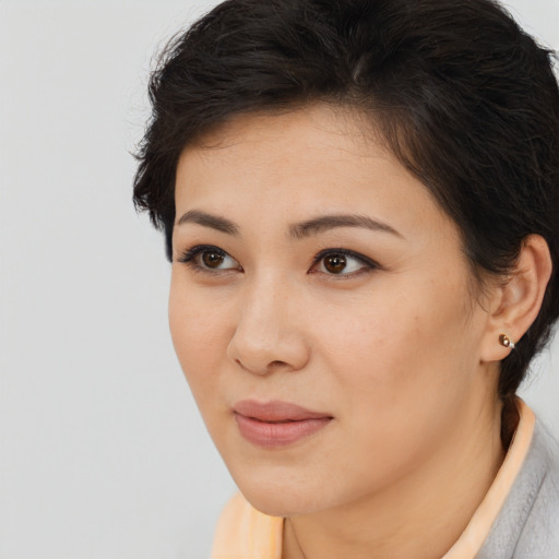 Joyful asian young-adult female with short  brown hair and brown eyes