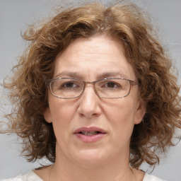 Joyful white middle-aged female with medium  brown hair and brown eyes