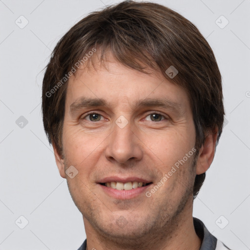 Joyful white adult male with short  brown hair and grey eyes