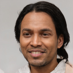 Joyful latino adult male with short  black hair and brown eyes