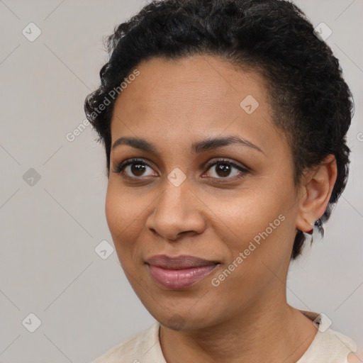 Joyful black young-adult female with short  brown hair and brown eyes