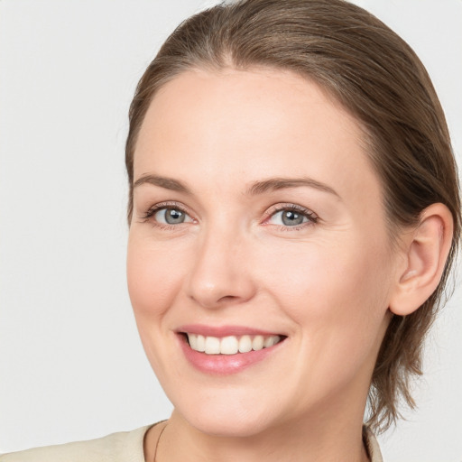 Joyful white young-adult female with medium  brown hair and blue eyes