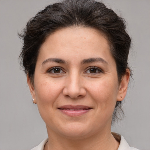 Joyful white adult female with short  brown hair and brown eyes