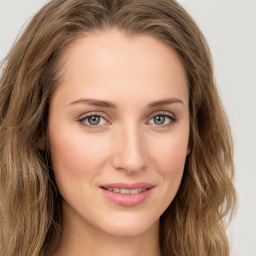 Joyful white young-adult female with long  brown hair and green eyes