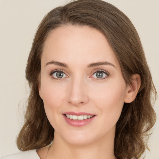 Joyful white young-adult female with medium  brown hair and green eyes