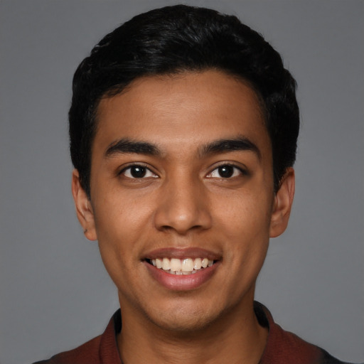 Joyful latino young-adult male with short  black hair and brown eyes