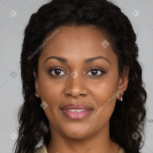 Joyful black young-adult female with long  brown hair and brown eyes