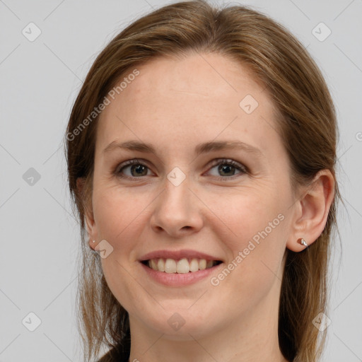 Joyful white young-adult female with long  brown hair and grey eyes