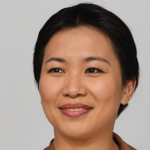 Joyful asian young-adult female with medium  black hair and brown eyes