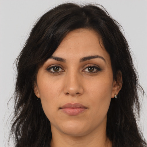 Joyful latino young-adult female with long  brown hair and brown eyes