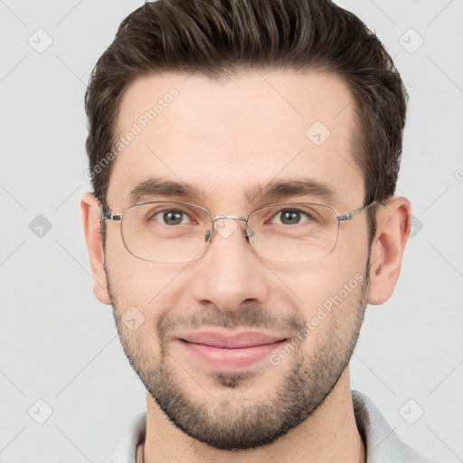 Joyful white adult male with short  brown hair and brown eyes