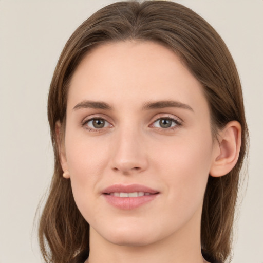 Joyful white young-adult female with medium  brown hair and green eyes