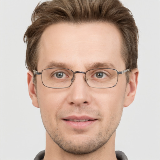 Joyful white adult male with short  brown hair and grey eyes