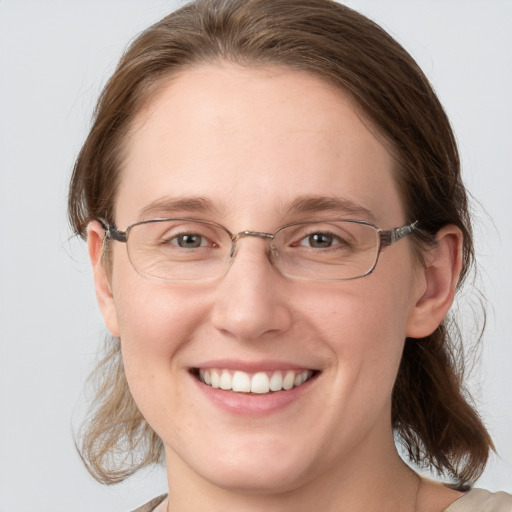 Joyful white adult female with medium  brown hair and blue eyes