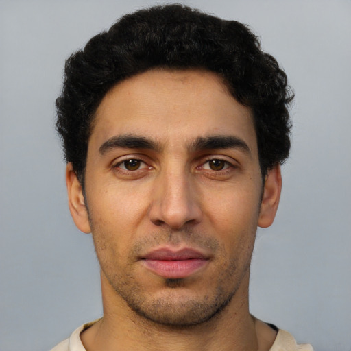 Joyful latino young-adult male with short  brown hair and brown eyes