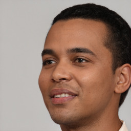 Joyful white young-adult male with short  black hair and brown eyes