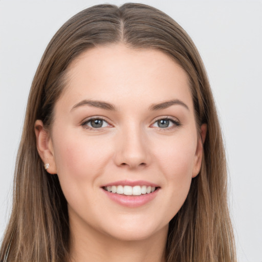 Joyful white young-adult female with long  brown hair and grey eyes