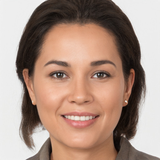 Joyful white young-adult female with medium  brown hair and brown eyes