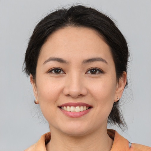 Joyful white young-adult female with medium  brown hair and brown eyes