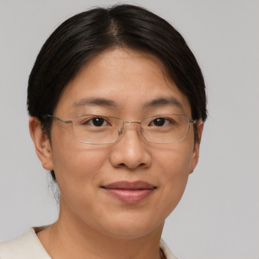 Joyful asian adult female with short  brown hair and brown eyes
