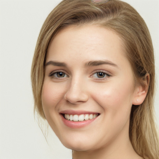 Joyful white young-adult female with long  brown hair and grey eyes