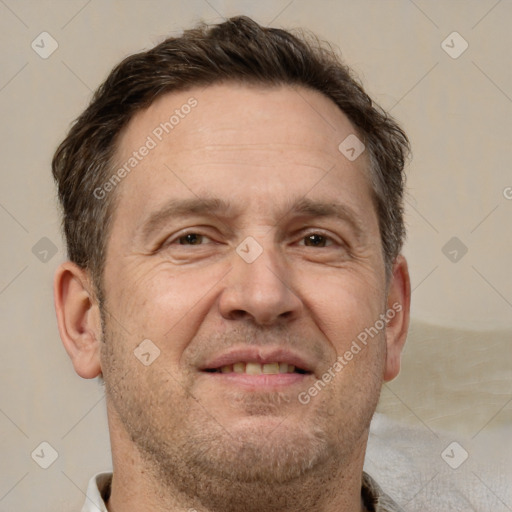 Joyful white adult male with short  brown hair and brown eyes