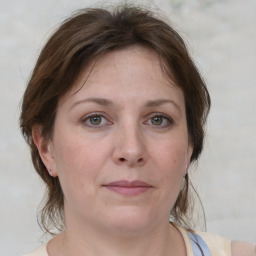 Joyful white adult female with medium  brown hair and grey eyes