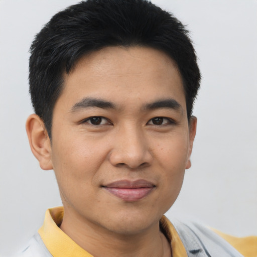 Joyful asian young-adult male with short  brown hair and brown eyes