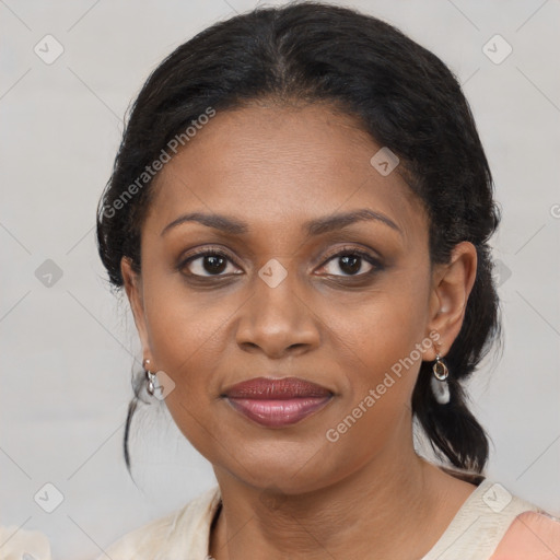 Joyful black adult female with medium  brown hair and brown eyes