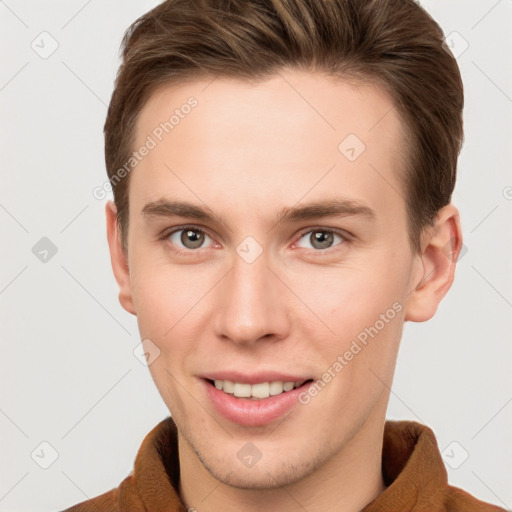 Joyful white young-adult male with short  brown hair and grey eyes