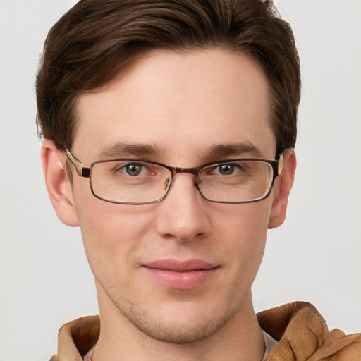 Joyful white young-adult male with short  brown hair and grey eyes