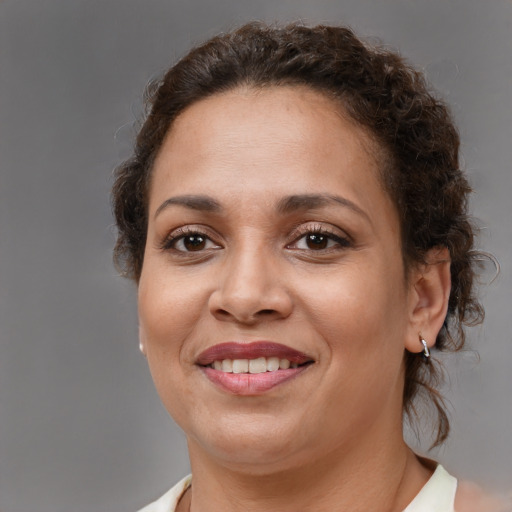 Joyful black young-adult female with medium  brown hair and brown eyes