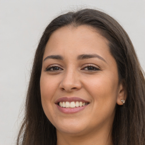 Joyful white young-adult female with long  brown hair and brown eyes