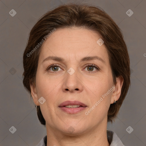 Joyful white adult female with medium  brown hair and grey eyes