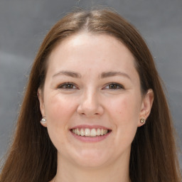 Joyful white young-adult female with long  brown hair and grey eyes