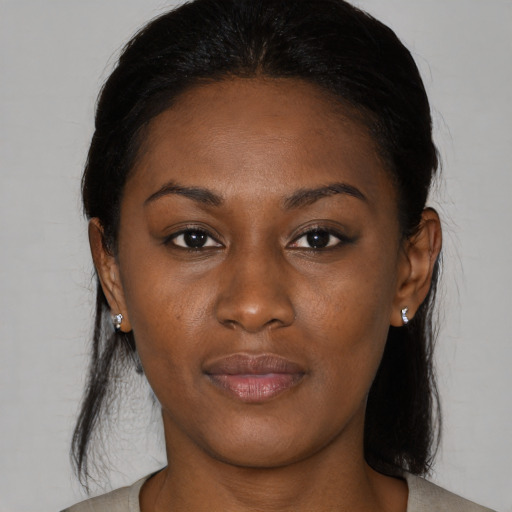 Joyful black young-adult female with medium  brown hair and brown eyes