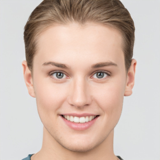 Joyful white young-adult female with short  brown hair and grey eyes