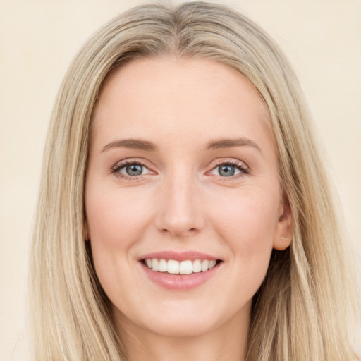 Joyful white young-adult female with long  brown hair and blue eyes