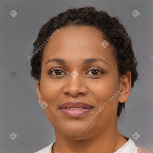 Joyful black adult female with short  brown hair and brown eyes