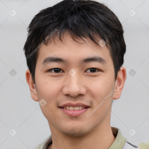 Joyful asian young-adult male with short  brown hair and brown eyes