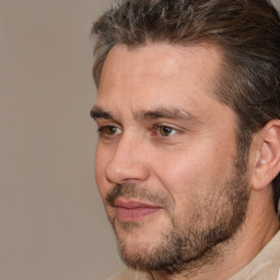 Joyful white adult male with short  brown hair and brown eyes