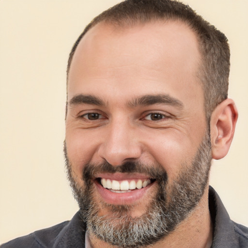 Joyful white adult male with short  black hair and brown eyes