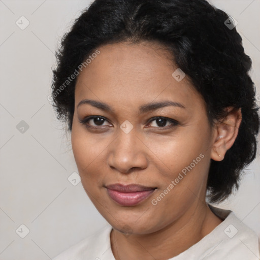 Joyful black adult female with medium  brown hair and brown eyes