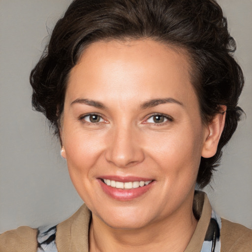 Joyful white adult female with medium  brown hair and brown eyes